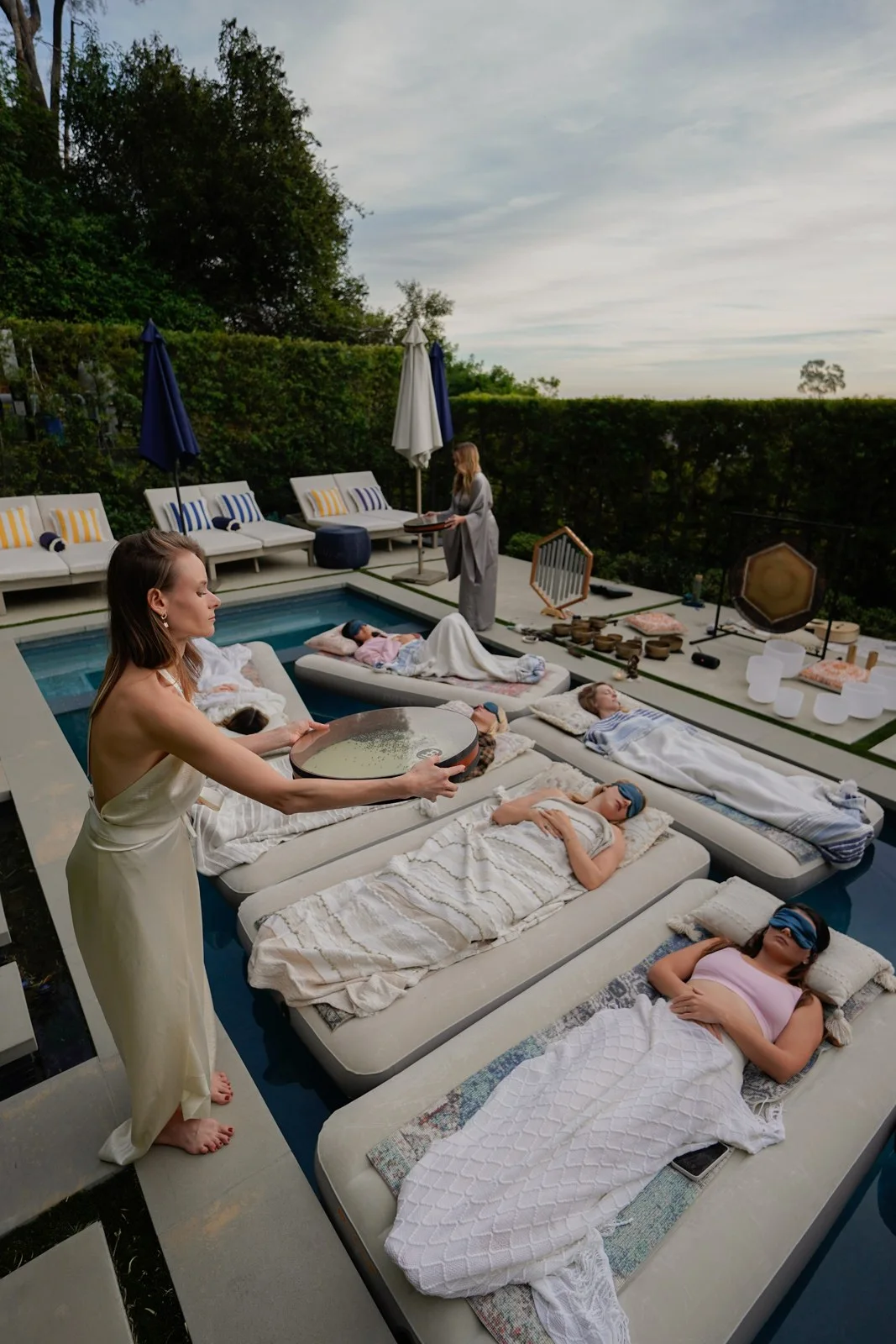 A guest resting on a floating mattress in a peaceful pool